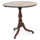 An early 19thC mahogany occasional table, the circular tilt top on a turned column and tripod base,