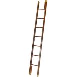 A folding mahogany and pressed leather folding library ladder, with a beaded outline and brass ends