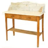 An Art Deco beech washstand, with a white marble top, with two frieze drawers on tapering legs with