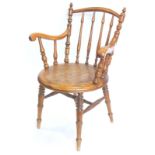 A late 19thC/early 20thC Austrian bentwood open armchair, with a spindle turned back, shaped arms an