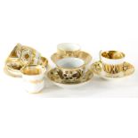 Various early 19thC English Coalport porcelain tea cups and saucers, decorated in gilt and white. (1