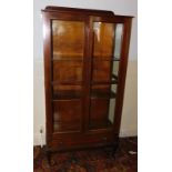 An early 20thC mahogany display cabinet, with two glazed doors, over single drawer and cabriole legs