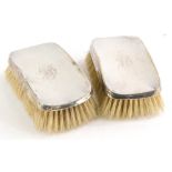 A pair of George V silver clothes brushes, each of oval form, initialled Chester 1911, 13cm wide. (2