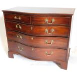 A George III mahogany serpentine chest, of two short and three long graduated drawers, oak lined and