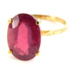 A 9ct gold dress ring, set with oval cut garnet, in a basket setting, on a plain band, yellow metal