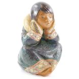 A Lladro ceramic figure of an Eskimo child, with head in hands, in a seated position, printed mark i