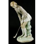 A Lladro porcelain figure of a female golfer, printed marks in blue to underside, 28cm high.