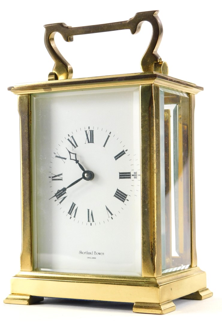 A brass carriage clock by Shortland Bowen, with bevelled glass sides, the movement stamped Made In E