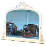 A cream painted oak overmantel mirror, with a carved ribbon and scroll decorated crest, and a moulde