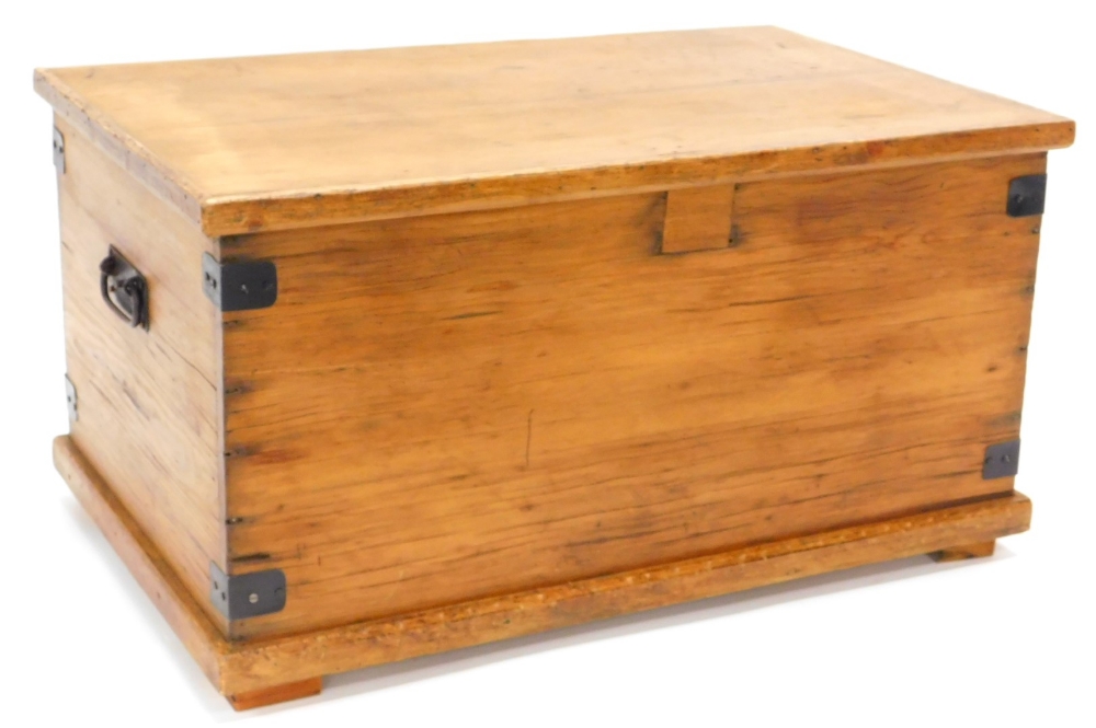 A stripped pine blanket box, with metal brackets, lock removed on a plinth, 79cm wide.