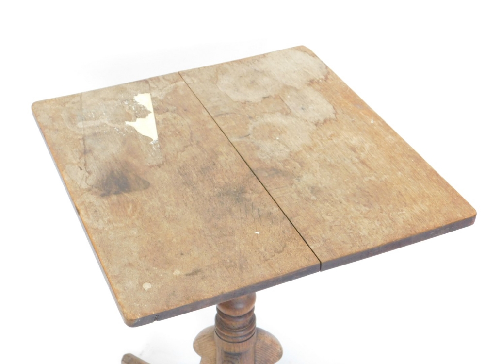 A 19thC oak tilt top occasional table, the rectangular top on a turned column and tripod base, 69cm - Image 2 of 2