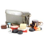 A brown leather Leica holdall case, containing mixed Leica accessories.