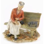 A Capodimonte porcelain figure of an old lady on a bench, beside a terrier puppy, the base decorated