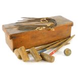 A vintage table top croquet set, in pine box, 46cm wide, to include mallets, ball and hoops, (a quan
