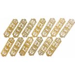A set of thirteen late 19thC gilt brass door finger plates, each pierced and cast in urns, pattern a