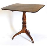 A 19thC oak occasional table, the rectangular top with rounded corners, on a turned column and tripo