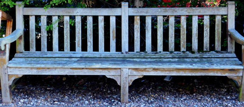 A large teak slatted garden bench, 246cm wide, etc.