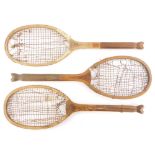 Three early 20thC Slazenger The Demon tennis rackets, each with a fishtail handle.
