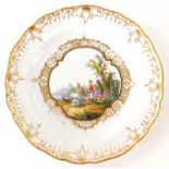 A Meissen cabinet plate painted with figures, and cattle in a landscape within gilt painted borders