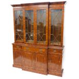 A yew veneered breakfront bookcase, in George III style with a moulded cornice, with four glazed doo