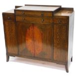 An Art Deco oak and amboyna sideboard, of stepped form with two long and two short drawers above fou