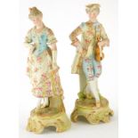 A pair of late 19thC continental bisque porcelain figures, on rococo bases of a gallant holding a vi