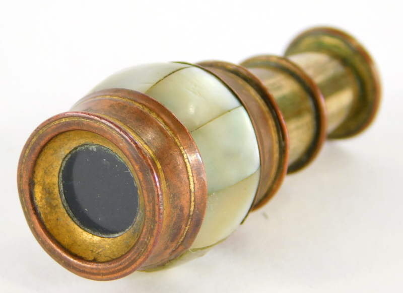 A 19thC miniature brass and copper two draw spy glass or monocular telescope, with a band of mother