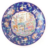 A modern Chinese circular dish, decorated with figures and boats, 41cm diameter.