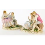 A pair of continental figure groups of lovers, in reclining poses with flowers and grapes, 13cm high