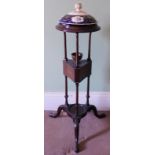 A 19thC mahogany wash stand, with circular moulded top in set with a Davenport style porcelain turee
