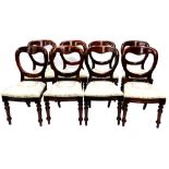 A set of eight Victorian mahogany balloon back dining chairs, each with a padded seat on