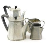 An Art Deco hand beaten pewter four piece coffee service, of angular form with black Bakelite handle