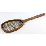 An early 20thC tennis racket, stamped Piggot and Co Bishops Gate, with fishtail handle, 68cm long.