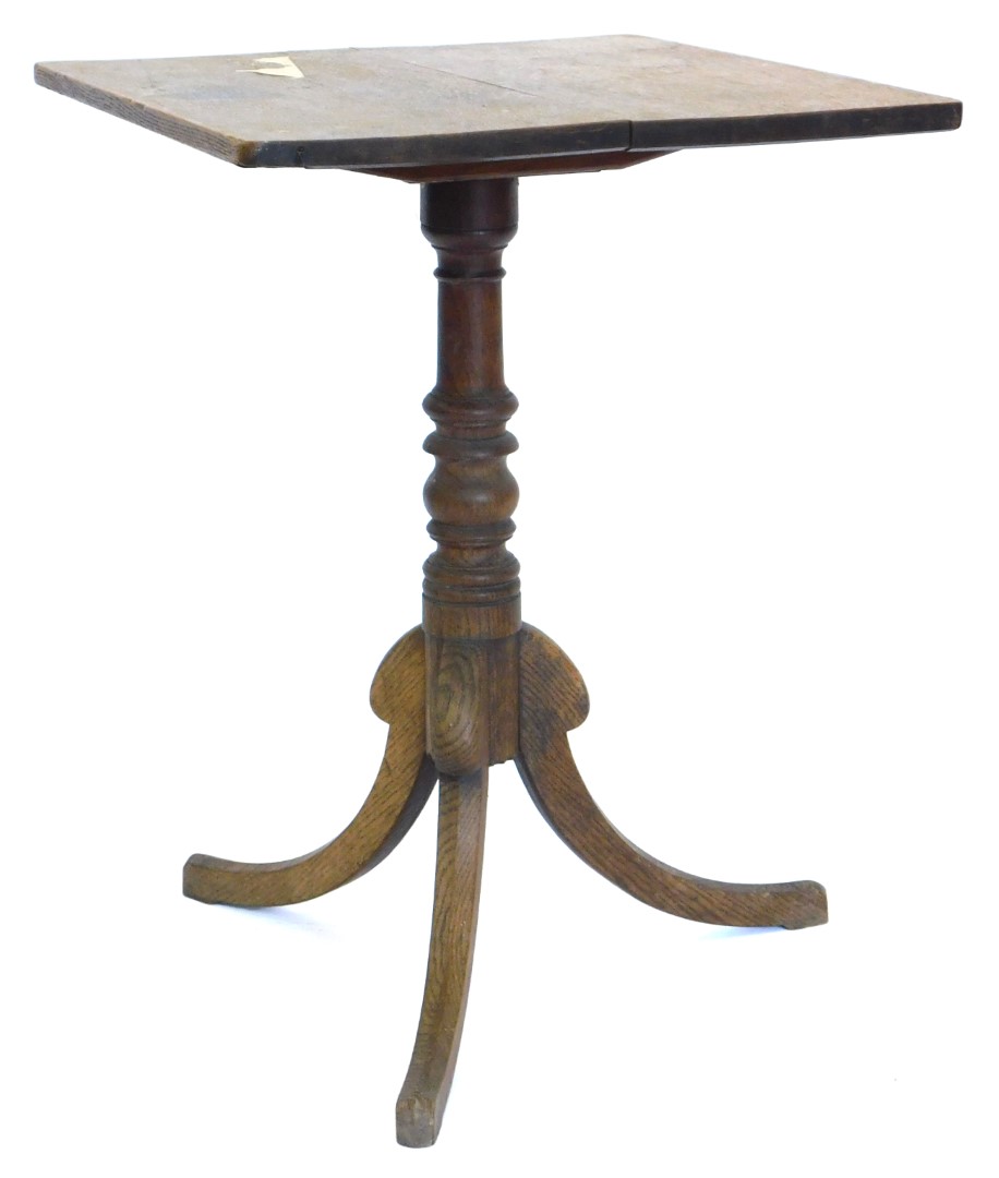 A 19thC oak tilt top occasional table, the rectangular top on a turned column and tripod base, 69cm