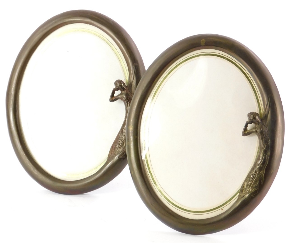 A pair of bronzed metal Art Nouveau style oval photograph frames, each decorated with the female fig