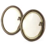 A pair of bronzed metal Art Nouveau style oval photograph frames, each decorated with the female fig