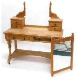 A Victorian ash Gothic dressing table, the top with two trinket drawers to each support, holding a r