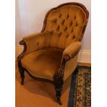 A Victorian carved walnut show frame spoon back open armchair, with scroll legs.