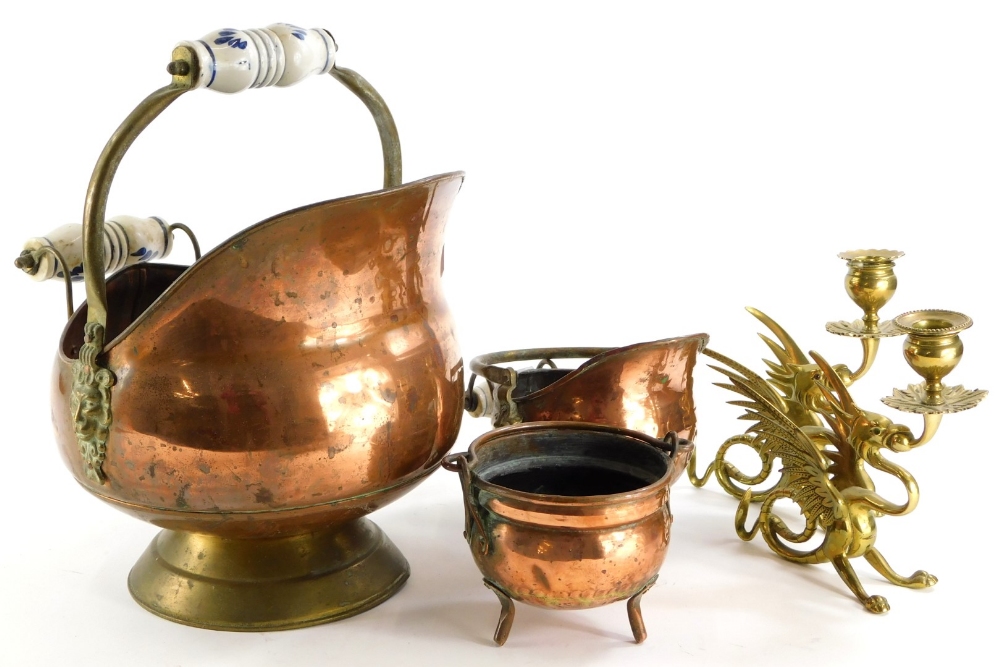 A collection of metal ware, to include a pair of brass griffin shaped candlesticks, copper coal scut