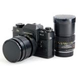 A black Leicaflex SL2 SLR camera, with a Leitz 35-70mm Vario-Elmar zoom lens, and a Leitz Elmarit R