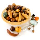Various modern carved wooden fruit to include pears, apples, etc., a glass handled magnifying glass,