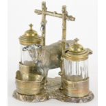 A Victorian silver plate and glass novelty cruet, cast with a cow and a stylised branch handle, the