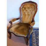 A Victorian mahogany scroll framed armchair, with buttoned upholstery and turned forelegs.