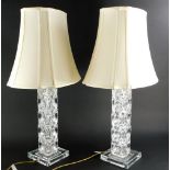 A pair of square section moulded glass table lamps with shades, the bases 48cm high to the top of t