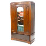 An early 20thC mahogany and satin walnut wardrobe, with a moulded cornice above a single mirrored do