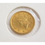 An 1854 gold USA one dollar coin, in presentation cardboard sleeve.