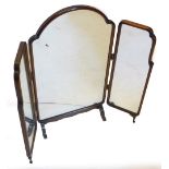 A mahogany three fold table mirror, of shaped outline with two hinged sections on scroll feet, 90cm