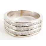 A 9ct white gold three row diamond set dress ring, set with various baguette cut stones, on a white