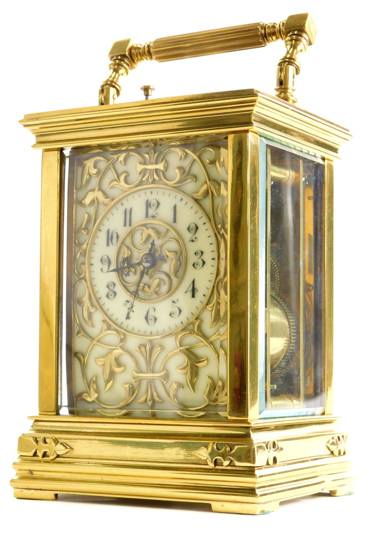 A late 19thC/early 20thC French carriage clock, the cream coloured dial applied with Gothic motifs,