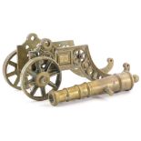 A brass model of a canon, with spoked wheels and pierced trunion, 43cm long.